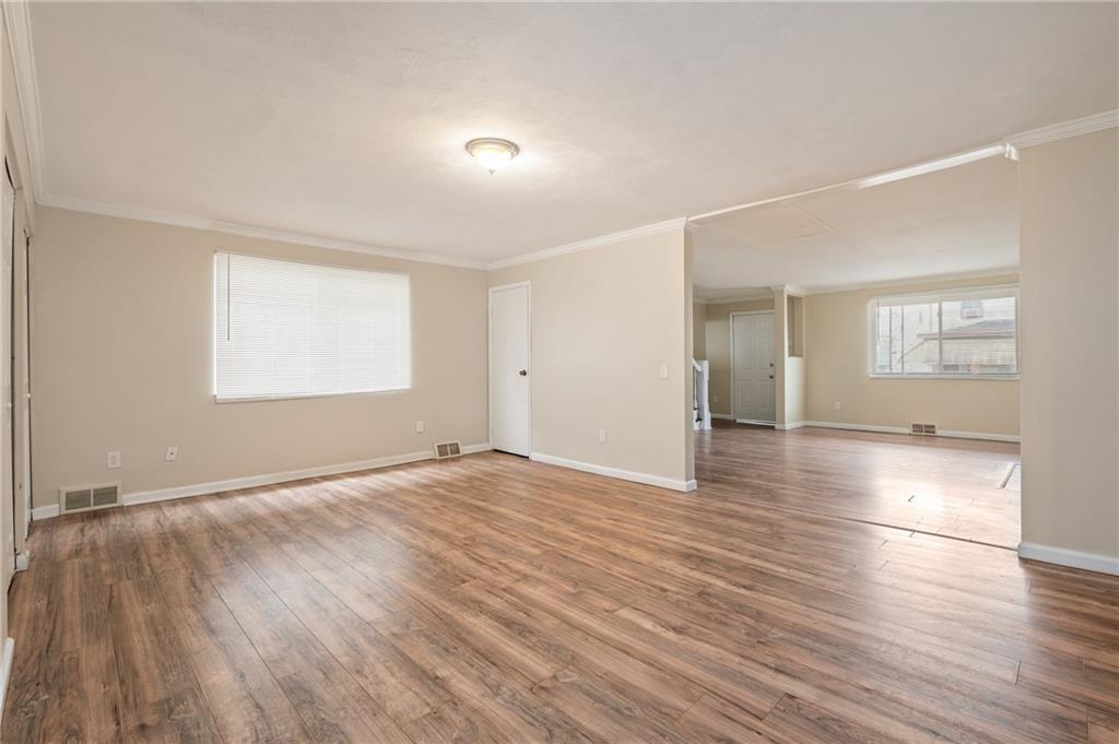 912 2nd Street McKees Rocks, PA 15136 - Photo 4 of 24 an empty room with wooden floor and windows