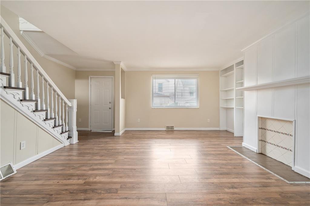 912 2nd Street McKees Rocks, PA 15136 - Photo 5 of 24 a view of an empty room with a window and wooden floor