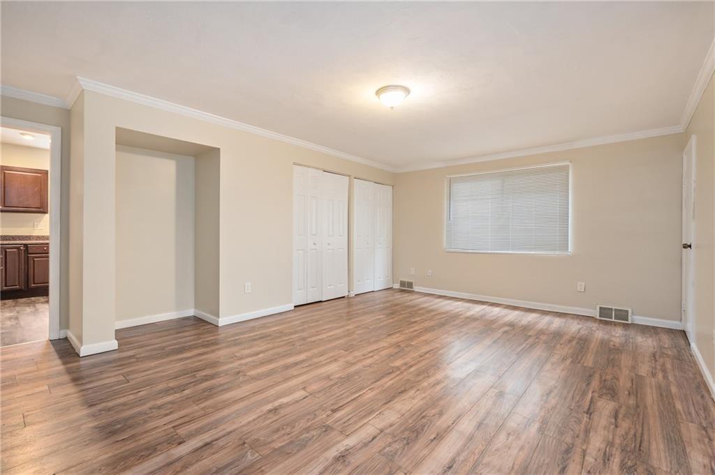 912 2nd Street McKees Rocks, PA 15136 - Photo 8 of 24 an empty room with wooden floor and windows