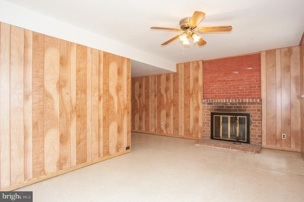 6601 China Grove Court Alexandria, VA 22310 - Photo 21 of 28 a view of an empty room with a fireplace and a window