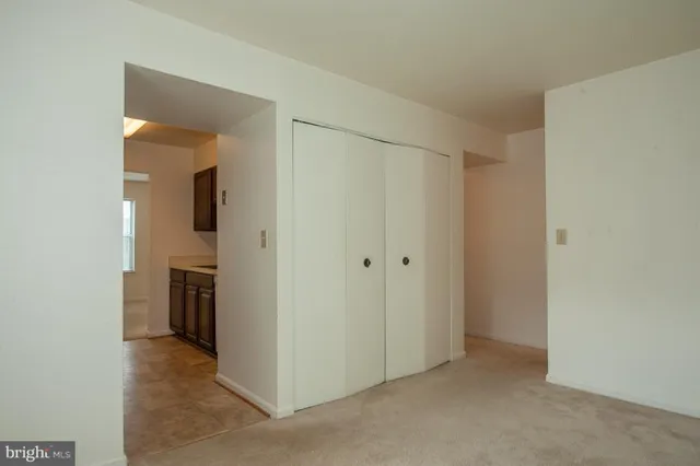 a view of a hallway with closet and wooden floor
