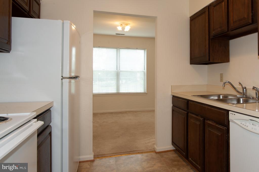 6601 China Grove Court Alexandria, VA 22310 - Photo 6 of 28 a kitchen with a sink cabinets and a window