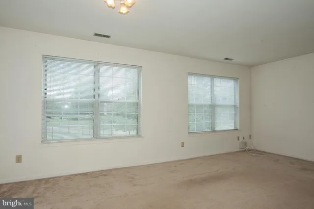 an empty room with a empty space and windows