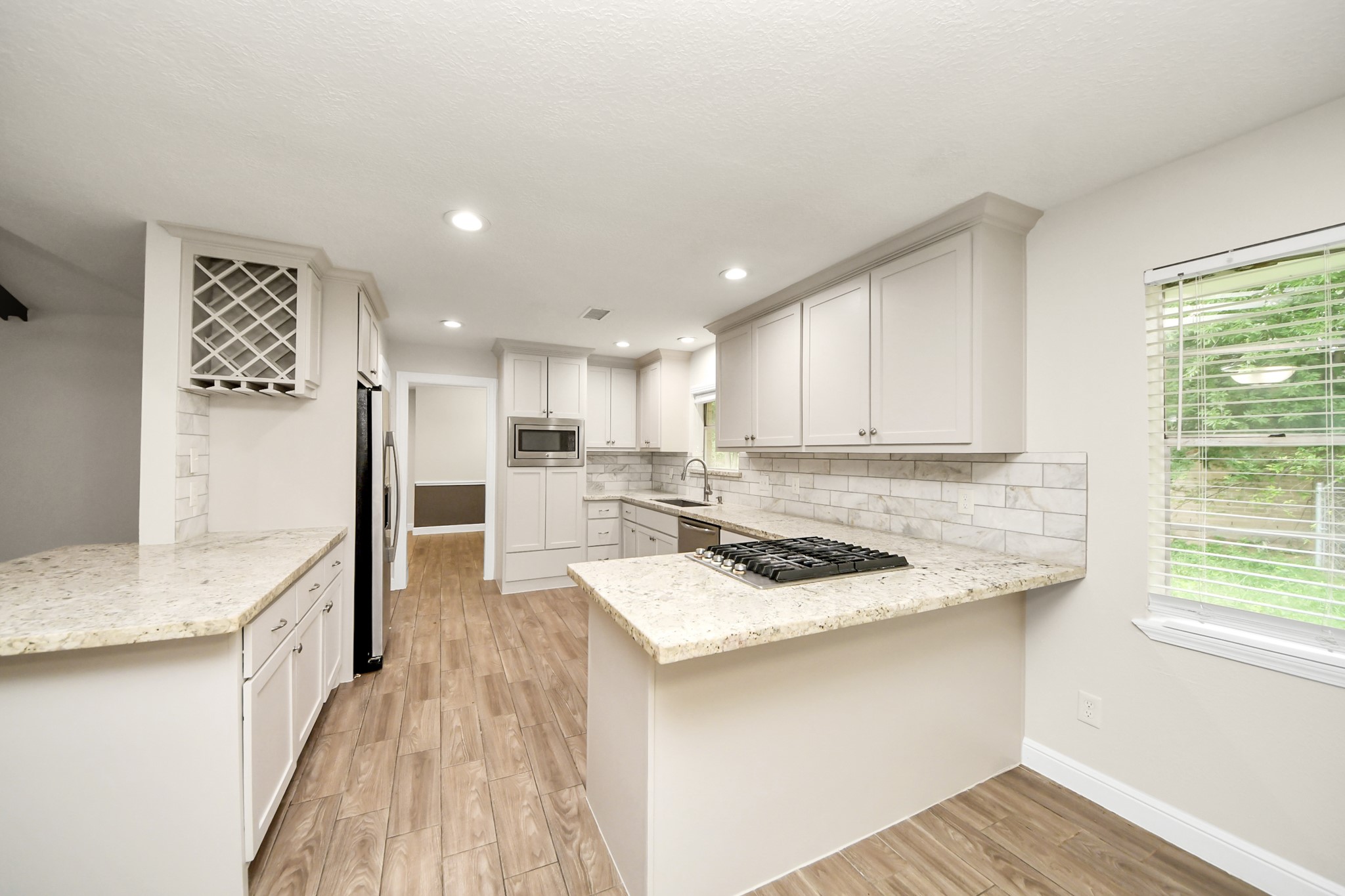 19435 Interstate 45 Spring, TX 77388 - Photo 11 of 24 a kitchen that has a lot of counter space and wooden floor