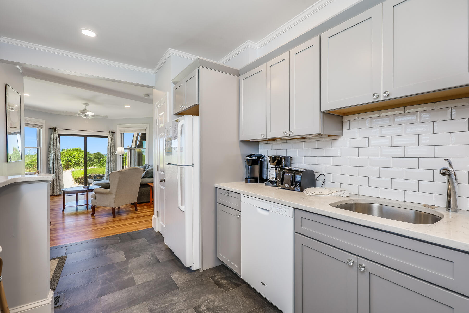 261 Linnell Landing Road, Unit 1 Brewster, MA 02631 - Photo 12 of 23 a kitchen with a sink cabinets and window