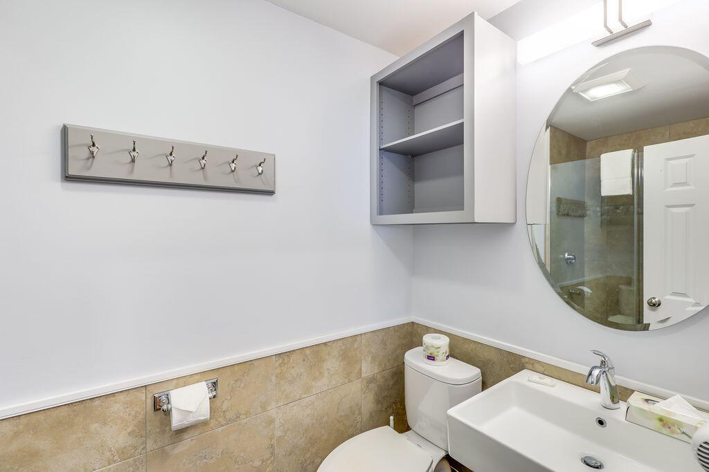 261 Linnell Landing Road, Unit 1 Brewster, MA 02631 - Photo 16 of 23 a bathroom with a toilet sink and mirror