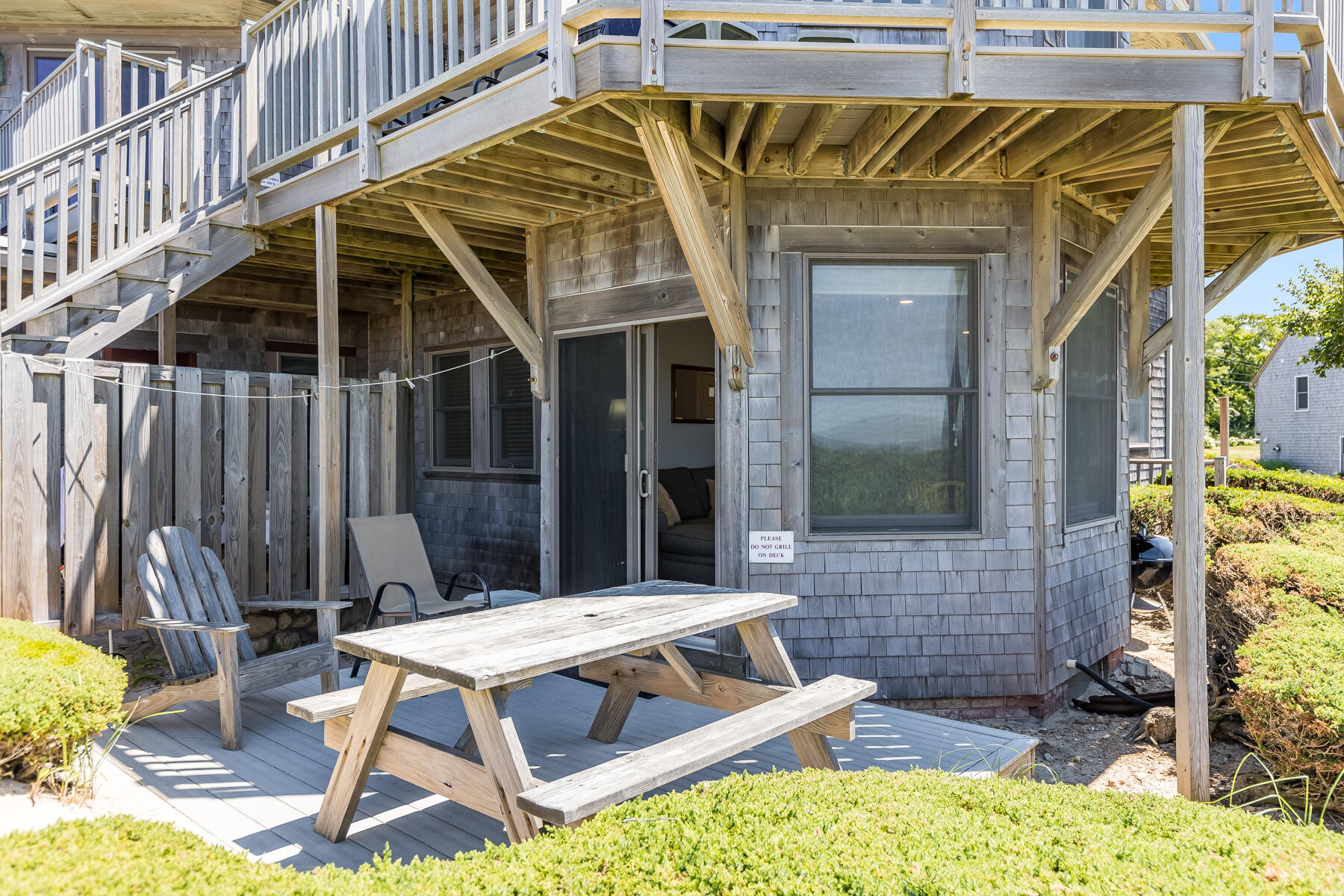 261 Linnell Landing Road, Unit 1 Brewster, MA 02631 - Photo 8 of 23 a view of a patio with a table and chairs