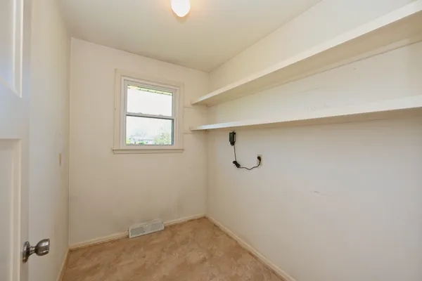 a view of an empty room and bathroom
