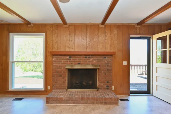 an empty room with furniture and a fireplace