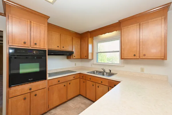 a kitchen with a sink stove and cabinets