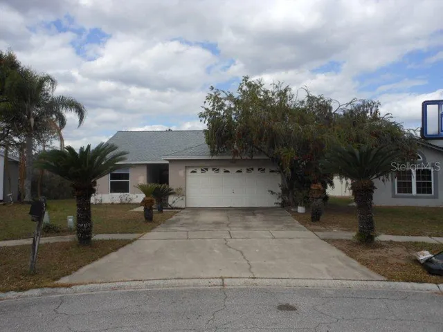 a view of a house with a yard and sitting area