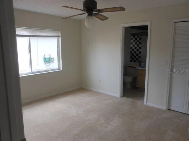 an empty room with windows and closet