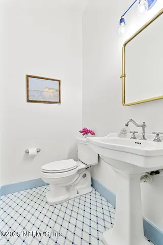 a bathroom with a sink toilet and a mirror