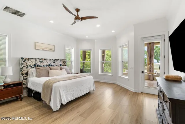 a bedroom with a large bed and a large window