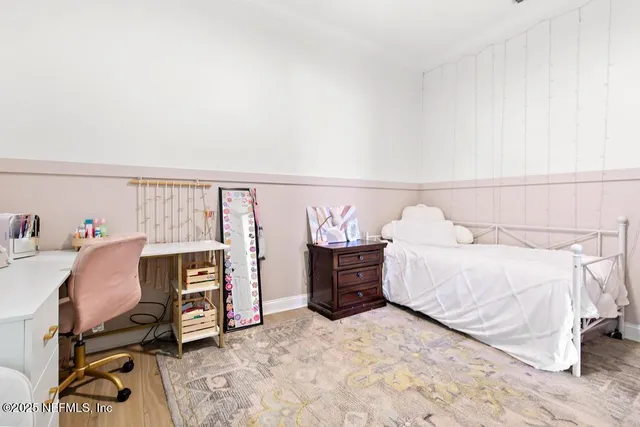 a bed room with a bed and a chair