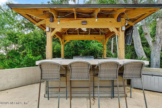 a view of a patio with table and chairs with wooden floor and fence