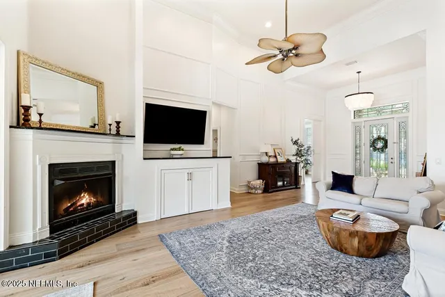 a living room with furniture a fireplace and a flat screen tv