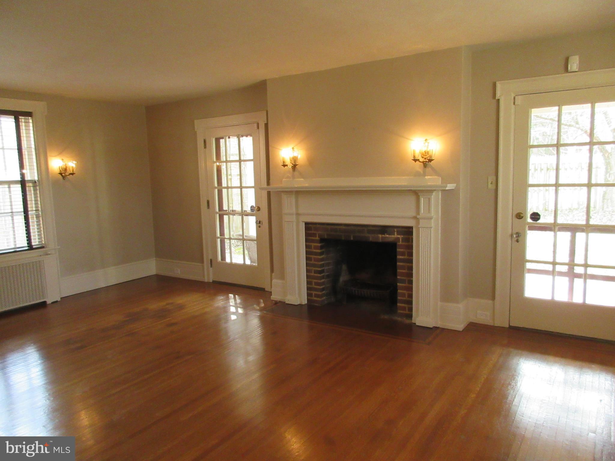 1100 Newlin Road York, PA 17403 - Photo 7 of 25 Living room with fireplace and doors to covered p.