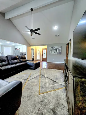 a living room with furniture and a flat screen tv