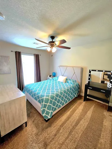 a view of bedroom with wooden floor