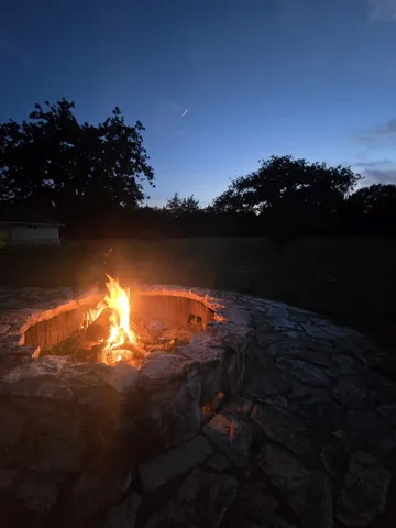 a view of a green field with an trees