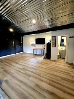 a view of a livingroom with an empty space and a fireplace