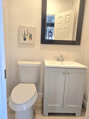 a bathroom with a toilet a sink and a window