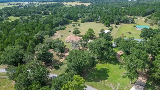 an aerial view of a house with a yard