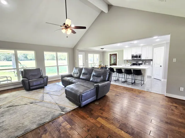 a kitchen with a dining table chairs refrigerator and a stove