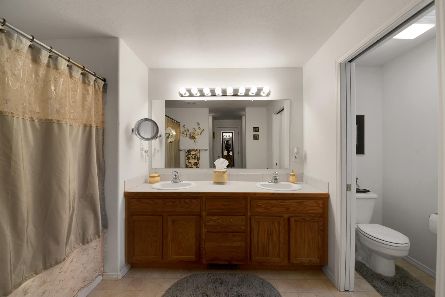 52311 Ammon Road La Pine, OR 97739 - Photo 25 of 39 a bathroom with a double vanity sink toilet mirror and shower