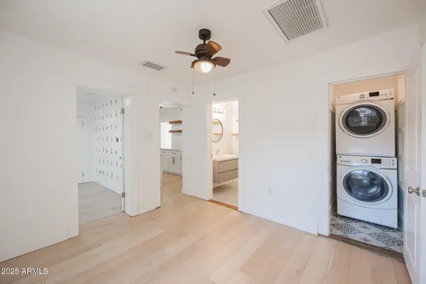 a view of a livingroom with wooden floor and a ceiling fan