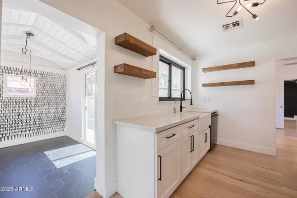 a kitchen with stainless steel appliances granite countertop a sink and cabinets