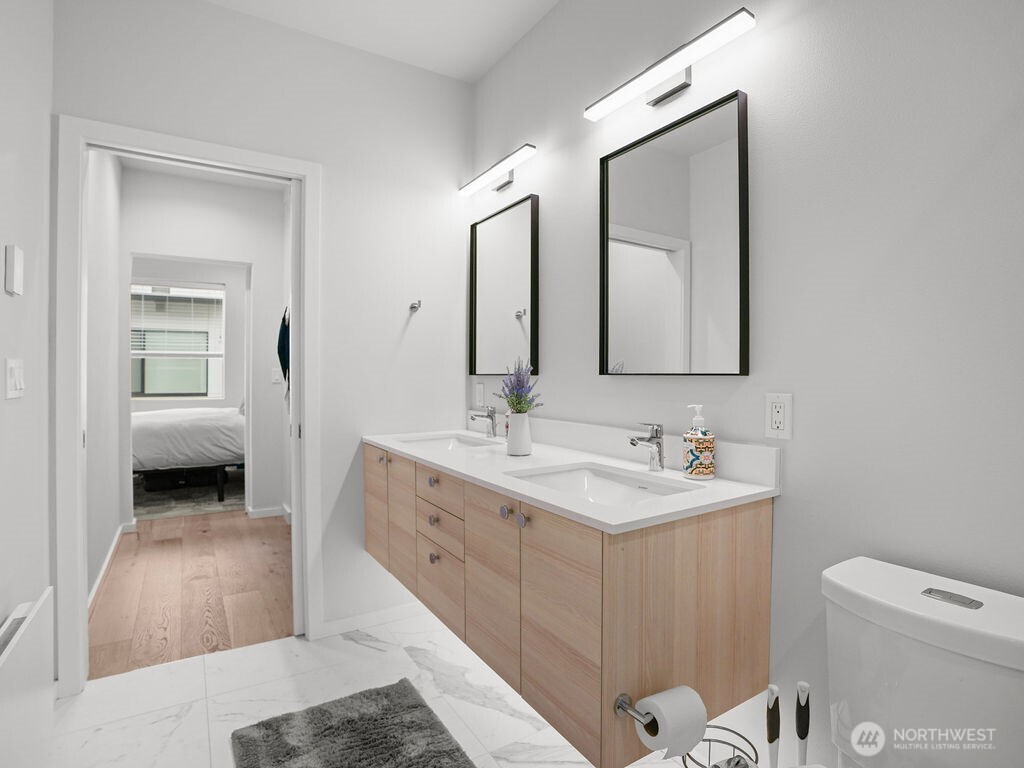 17338 Bothell Way Northeast, Unit E Bothell, WA 98011 - Photo 11 of 26 a en suite bathroom with a double vanity sink and a mirror