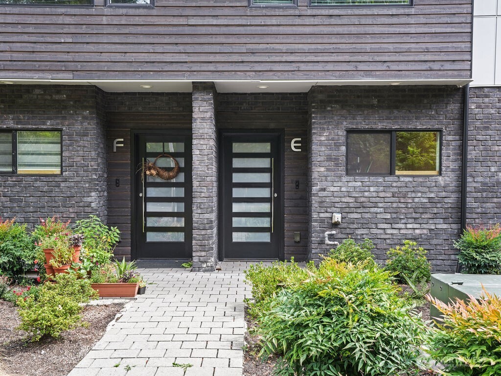 17338 Bothell Way Northeast, Unit E Bothell, WA 98011 - Photo 23 of 26 a front view of a building with potted plants