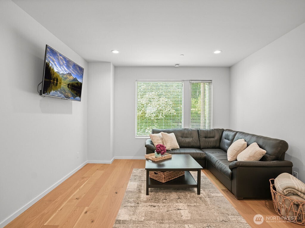 17338 Bothell Way Northeast, Unit E Bothell, WA 98011 - Photo 8 of 26 a living room with furniture and a flat screen tv
