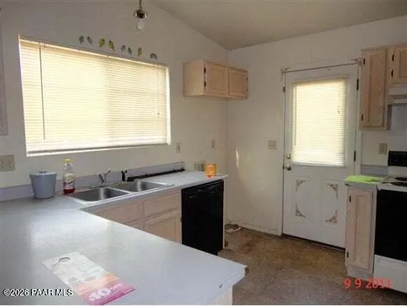 a kitchen with granite countertop a sink and a stove top oven