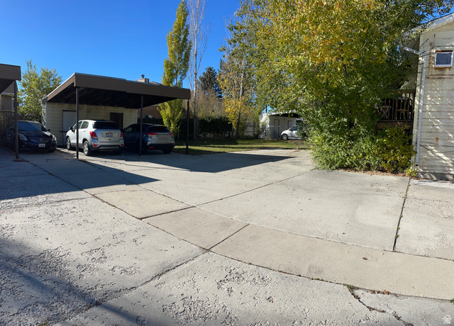 3977 Rivendell Road, Unit AB Taylorsville, UT 84129 - Photo 4 of 14 View of vehicle parking with driveway and a carport