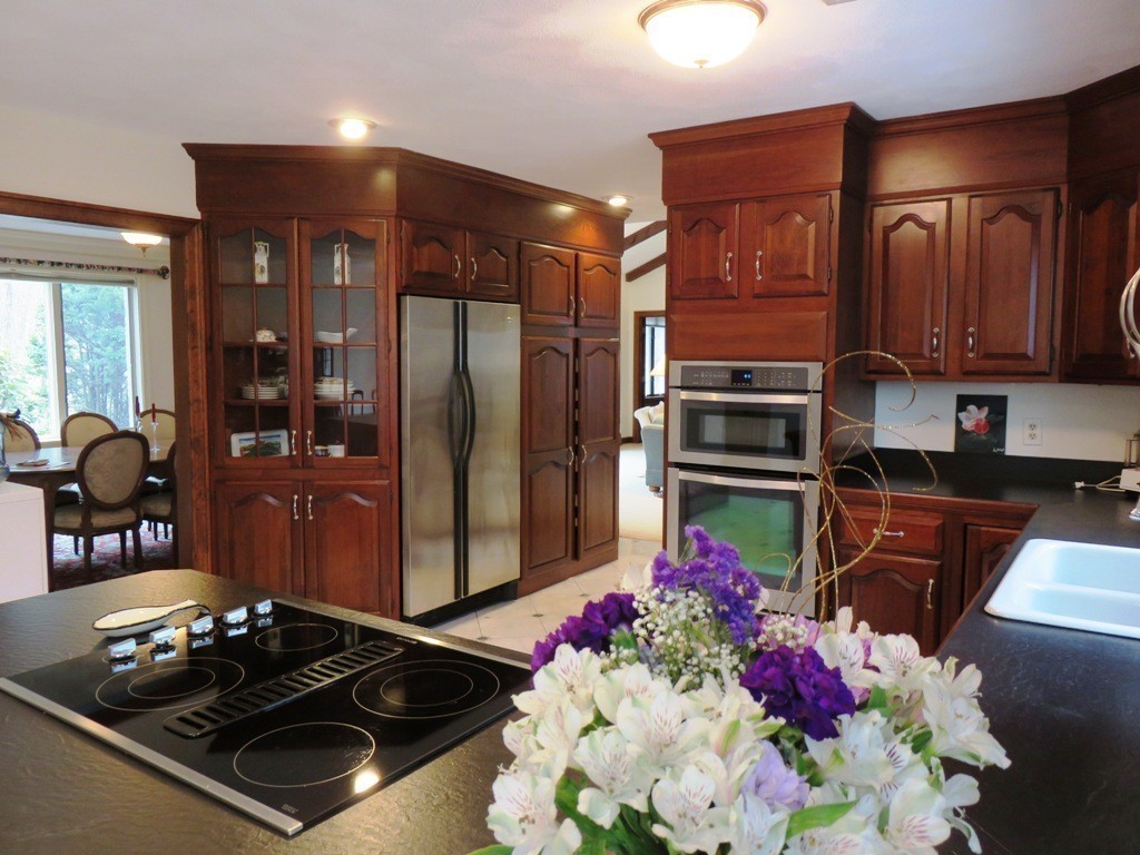764 Main Street Boxford, MA 01921 - Photo 8 of 28 a kitchen with stainless steel appliances granite countertop a stove refrigerator and cabinets