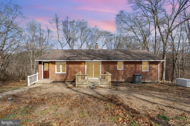 a front view of a house with yard and seating area