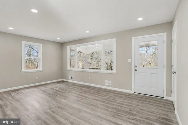 a view of room with window and wooden floor