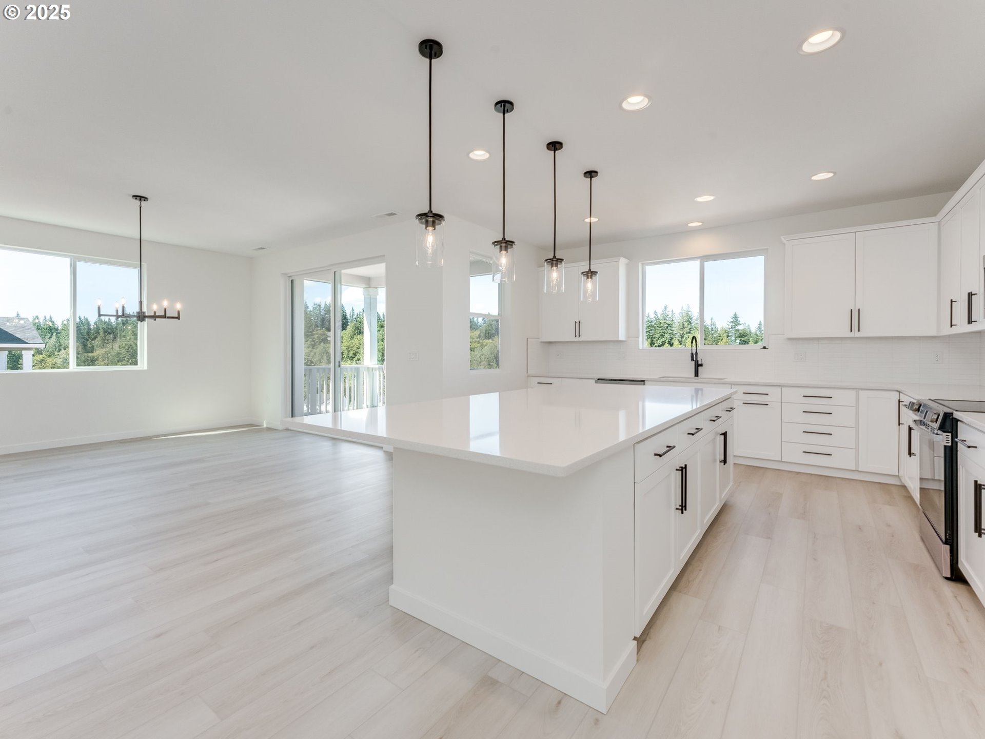 2151 Northeast Ridge Run Lane Estacada, OR 97023 - Photo 18 of 46 a large white kitchen with a large window a sink and stainless steel appliances