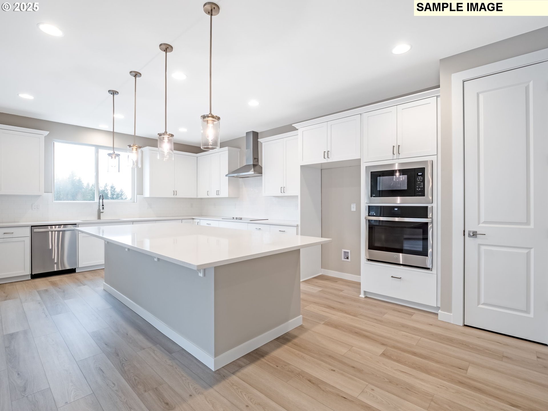 2151 Northeast Ridge Run Lane Estacada, OR 97023 - Photo 4 of 46 a large kitchen with stainless steel appliances kitchen island granite countertop a stove a refrigerator and a view of living room with wooden floor