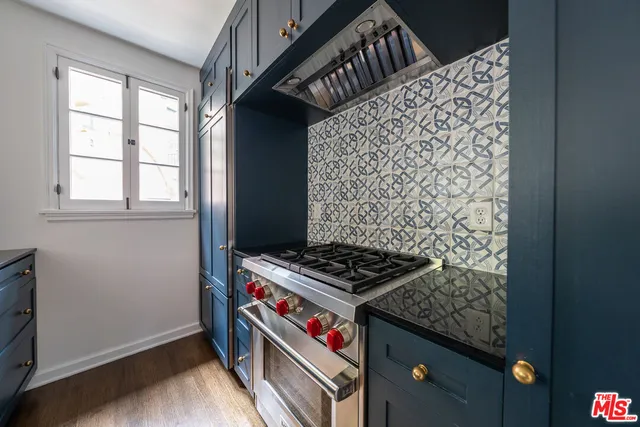 a view of bathroom with a sink a window and a wooden floor