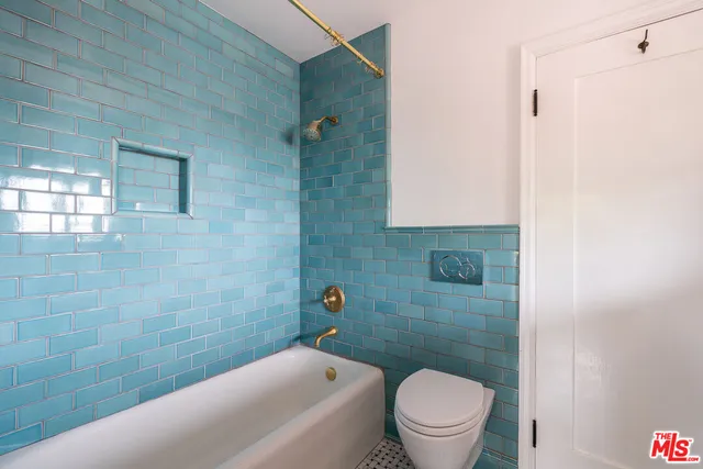 a bathroom with a toilet and a shower