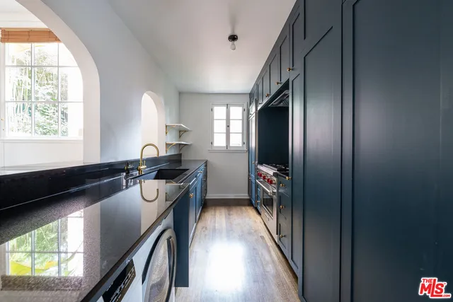a view of a hallway with furniture and a window