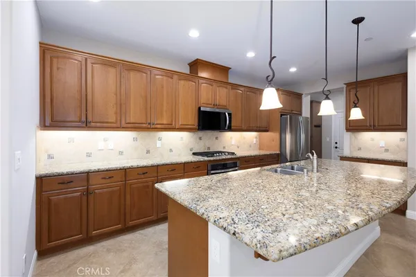 a kitchen with a stove a sink and a refrigerator