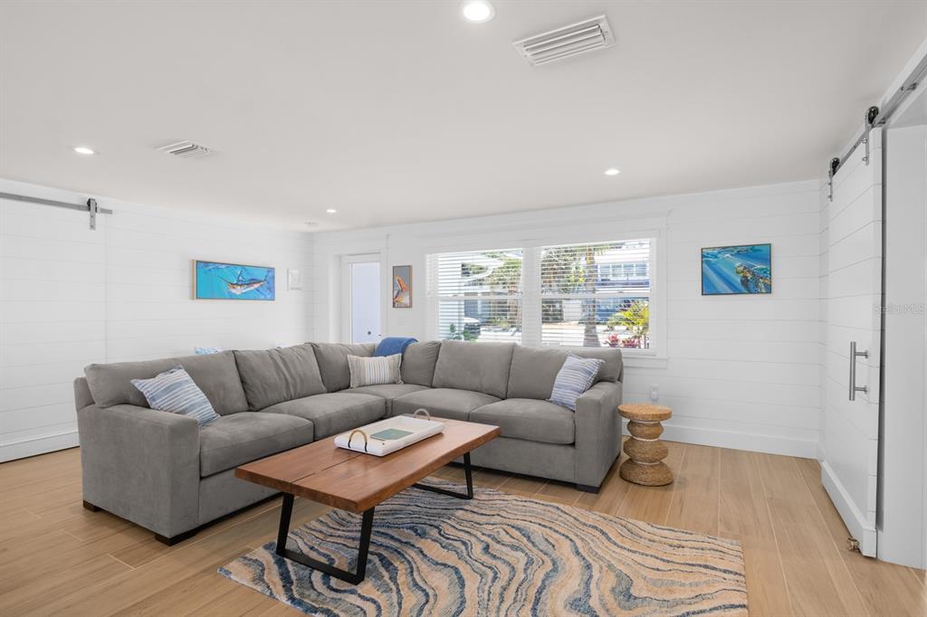 306 South Bay Boulevard Anna Maria, FL 34216 - Photo 11 of 44 a living room with furniture and a wooden floor