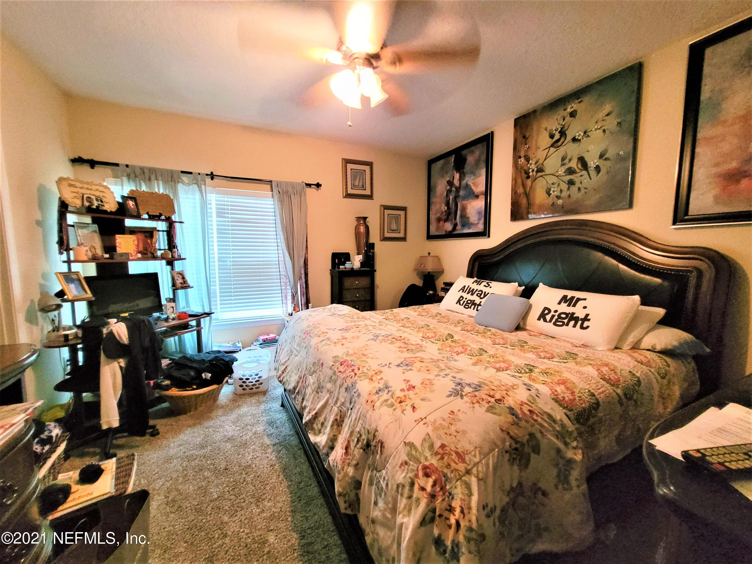2190 Monument Road, Unit 104 Jacksonville, FL 32225 - Photo 15 of 27 a bedroom with a bed and a wall painting