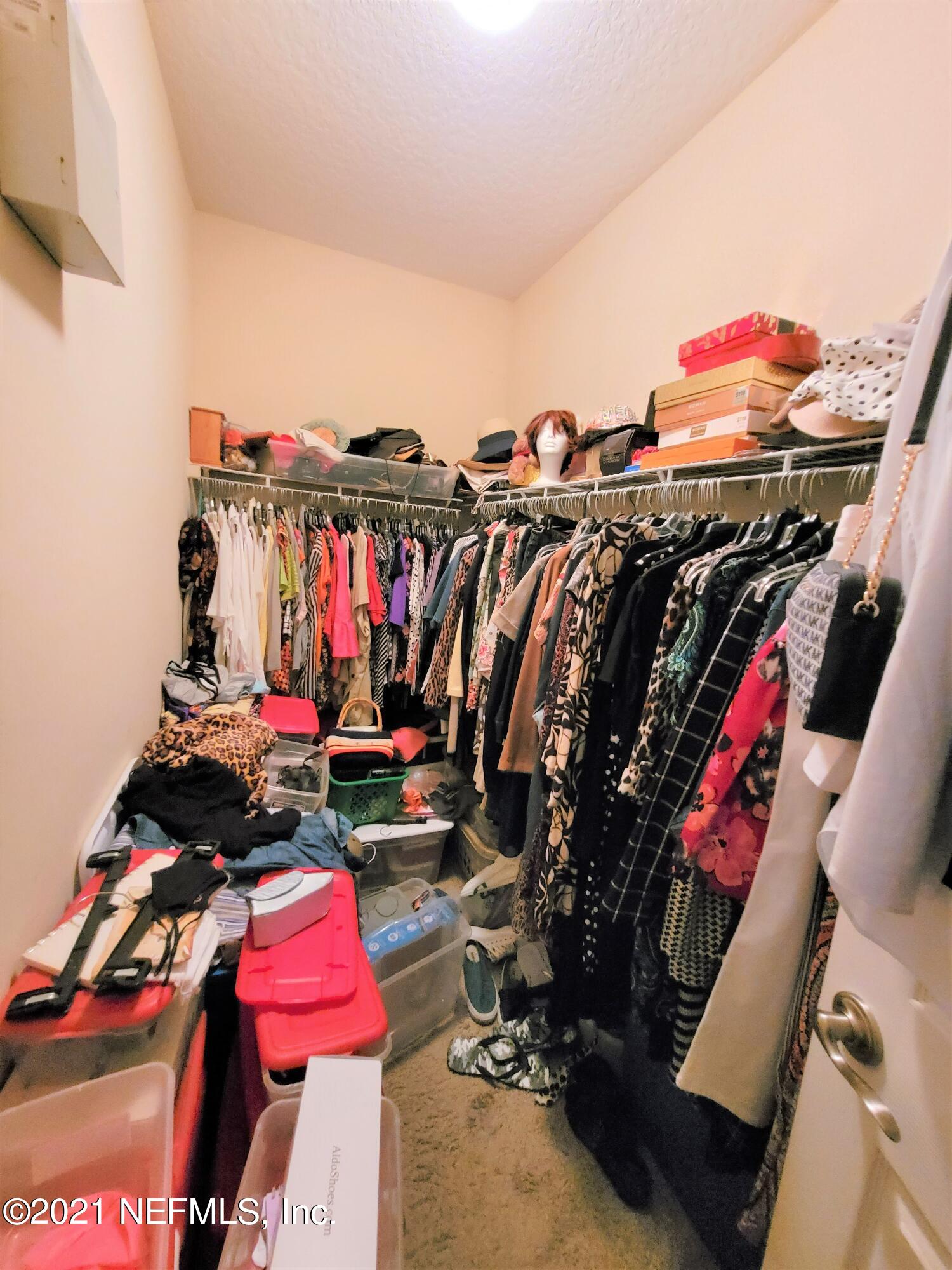 2190 Monument Road, Unit 104 Jacksonville, FL 32225 - Photo 18 of 27 a view of walk in closet with clothes and shoes