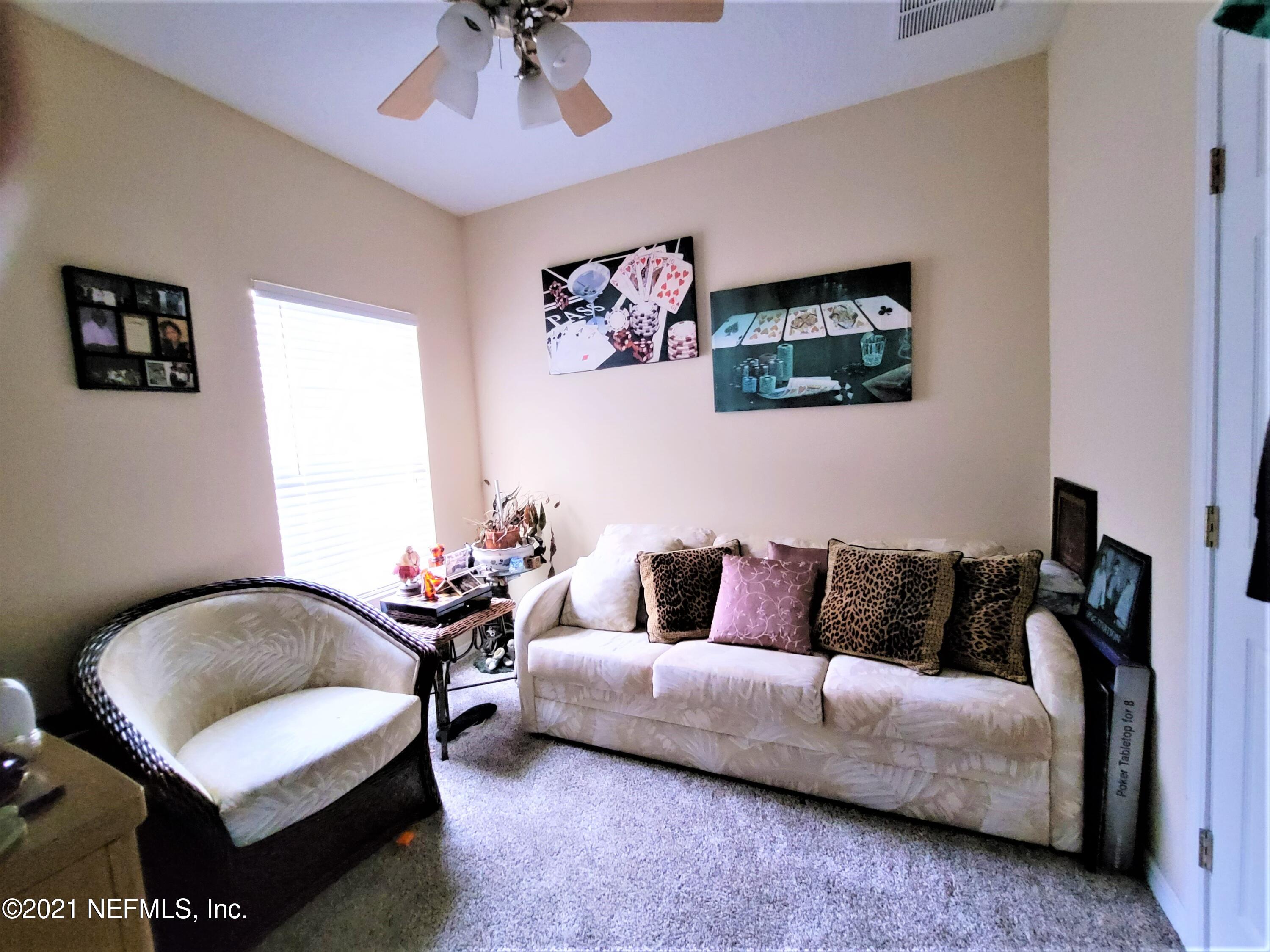 2190 Monument Road, Unit 104 Jacksonville, FL 32225 - Photo 19 of 27 a living room with furniture and a potted plant